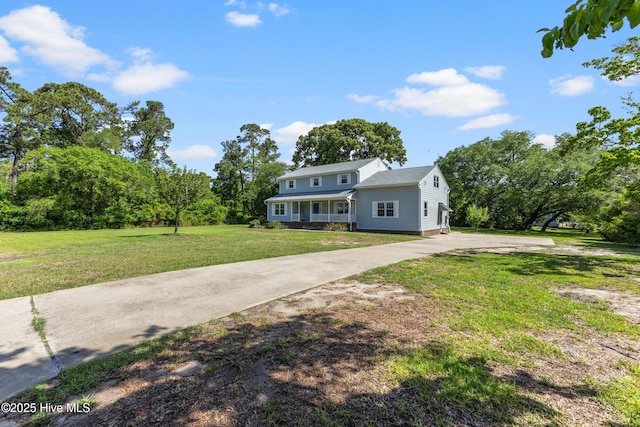 209 Inlet Dr, Wilmington, NC 28411 - traditional-style house with a front lawn and concrete driveway