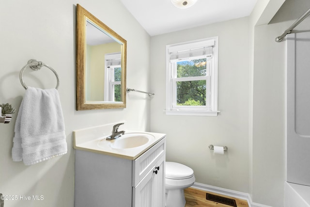 209 Inlet Dr, Wilmington, NC 28411 - bathroom with vanity, toilet, baseboards, and wood finished floors