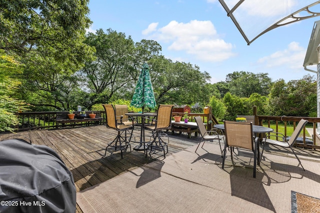 209 Inlet Dr, Wilmington, NC 28411 - view of patio featuring outdoor dining area, a wooden deck, and view of scattered trees