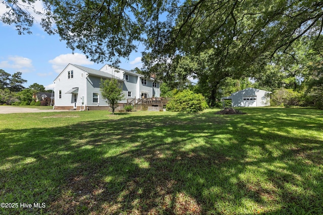 209 Inlet Dr, Wilmington, NC 28411 - view of green lawn featuring a detached garage and a wooden deck