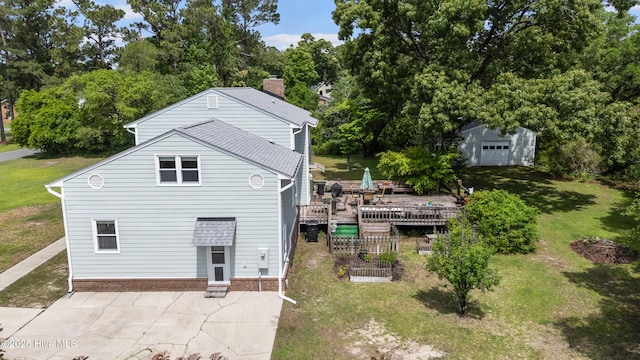 209 Inlet Dr, Wilmington, NC 28411 - rear view of house featuring a deck, a yard, view of wooded area, an outbuilding, and a chimney