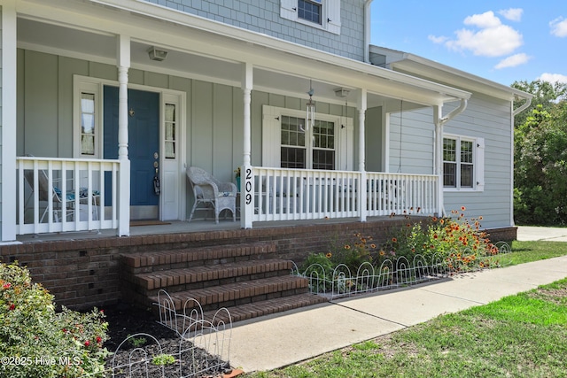 209 Inlet Dr, Wilmington, NC 28411 - doorway to property with covered porch and board and batten siding