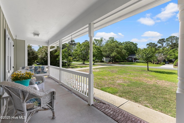 209 Inlet Dr, Wilmington, NC 28411 - porch with a lawn and view of wooded area