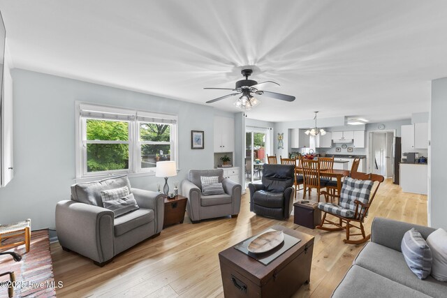209 Inlet Dr, Wilmington, NC 28411 - living area with a ceiling fan, light wood finished floors, and a chandelier
