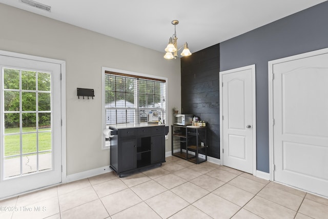 112 Norine Dr, Holly Ridge, NC 28445 - dining area featuring light tile patterned floors, a chandelier, and baseboards