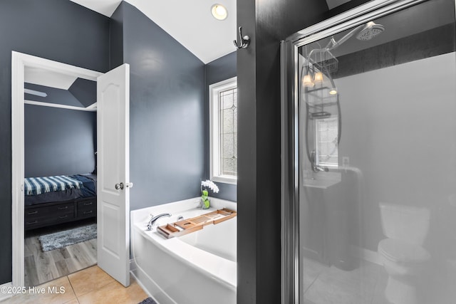 112 Norine Dr, Holly Ridge, NC 28445 - ensuite bathroom featuring a stall shower, tile patterned flooring, a garden tub, and lofted ceiling