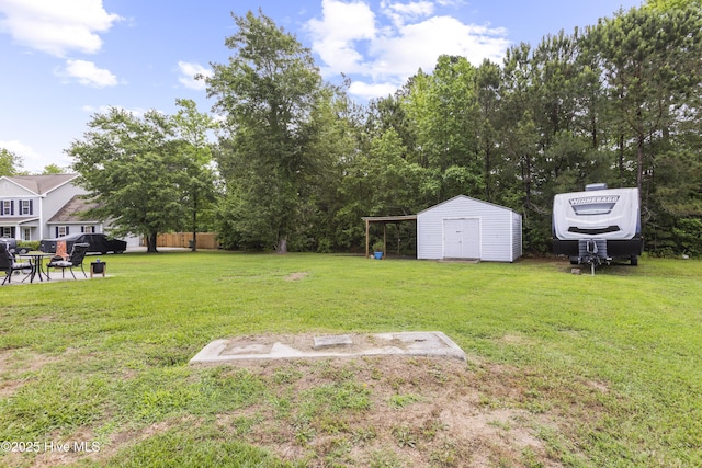 112 Norine Dr, Holly Ridge, NC 28445 - view of green lawn featuring a storage unit and an outdoor structure