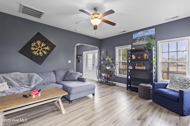 112 Norine Dr, Holly Ridge, NC 28445 - living room with arched walkways, wood finished floors, ceiling fan, and baseboards