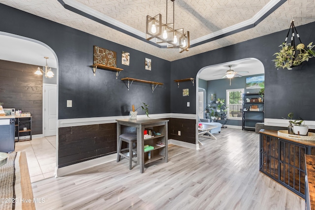 112 Norine Dr, Holly Ridge, NC 28445 - bar area with arched walkways, a chandelier, ceiling fan, a raised ceiling, and wood finished floors