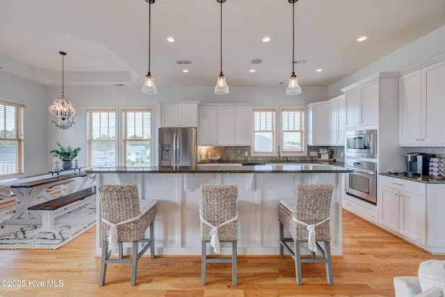 353 Spicer Lake Dr, Holly Ridge, NC 28445 - kitchen with appliances with stainless steel finishes, tasteful backsplash, white cabinets, a kitchen breakfast bar, and recessed lighting