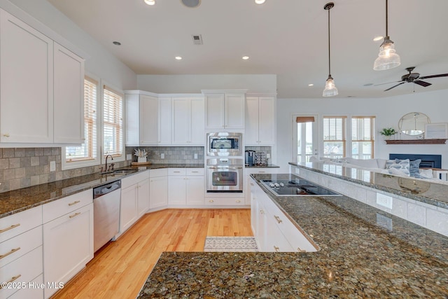 353 Spicer Lake Dr, Holly Ridge, NC 28445 - kitchen with stainless steel appliances, light wood finished floors, open floor plan, recessed lighting, and a sink