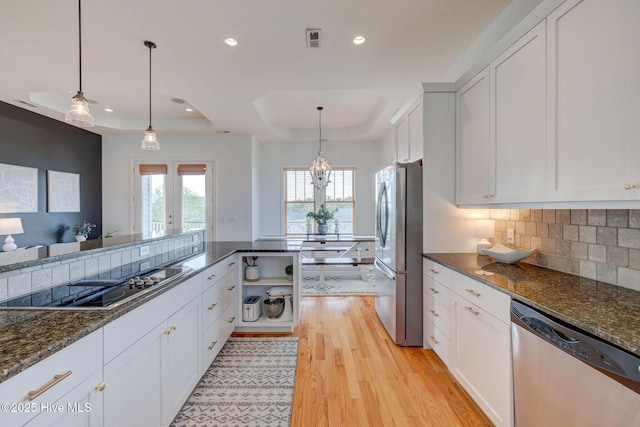 353 Spicer Lake Dr, Holly Ridge, NC 28445 - kitchen with appliances with stainless steel finishes, a raised ceiling, light wood-type flooring, white cabinets, and recessed lighting