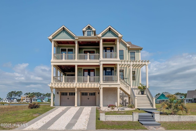 353 Spicer Lake Dr, Holly Ridge, NC 28445 - beach home with a balcony, stairway, driveway, a garage, and french doors
