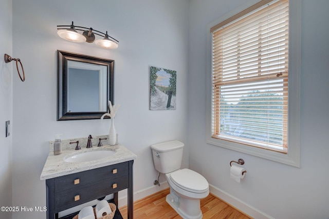 353 Spicer Lake Dr, Holly Ridge, NC 28445 - half bathroom with wood finished floors, toilet, vanity, and baseboards