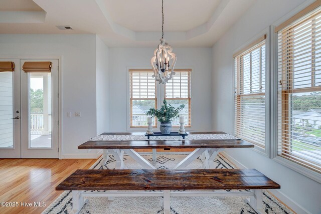 353 Spicer Lake Dr, Holly Ridge, NC 28445 - dining room featuring a raised ceiling, a chandelier, wood finished floors, french doors, and baseboards