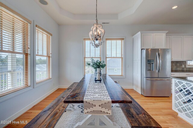353 Spicer Lake Dr, Holly Ridge, NC 28445 - dining space with a chandelier, plenty of natural light, and light wood-type flooring