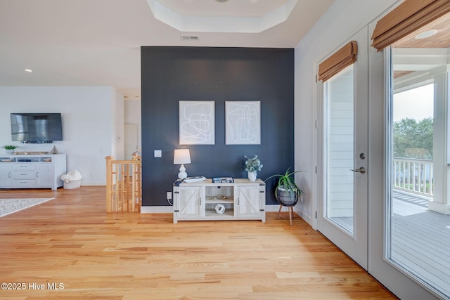 353 Spicer Lake Dr, Holly Ridge, NC 28445 - entrance foyer with light wood finished floors, a tray ceiling, and baseboards