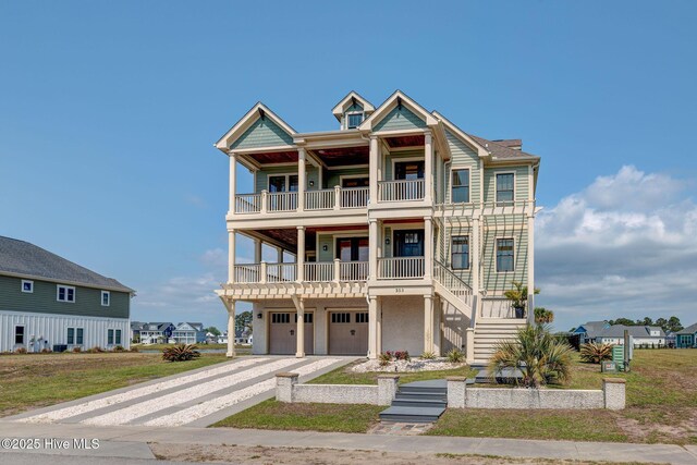 353 Spicer Lake Dr, Holly Ridge, NC 28445 - raised beach house with a balcony, a garage, driveway, and stairs