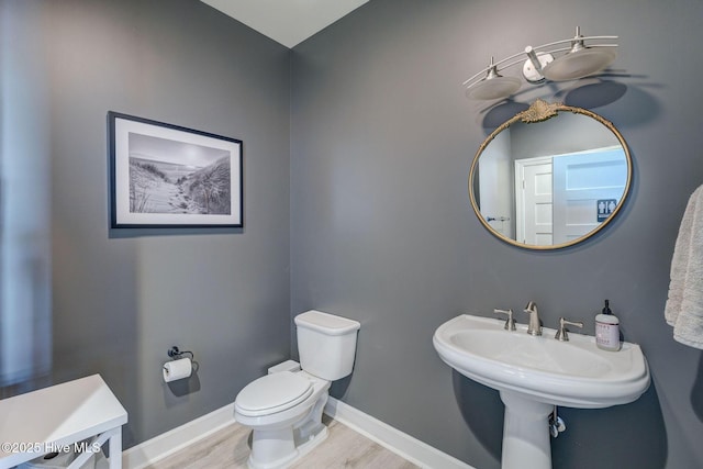 353 Spicer Lake Dr, Holly Ridge, NC 28445 - half bath with toilet, wood finished floors, and baseboards