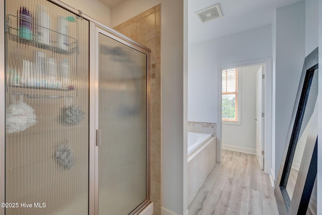 353 Spicer Lake Dr, Holly Ridge, NC 28445 - full bathroom with wood finished floors, a shower stall, and a bath