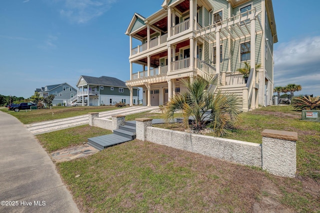 353 Spicer Lake Dr, Holly Ridge, NC 28445 - view of front of house with a balcony, a garage, a front lawn, and concrete driveway