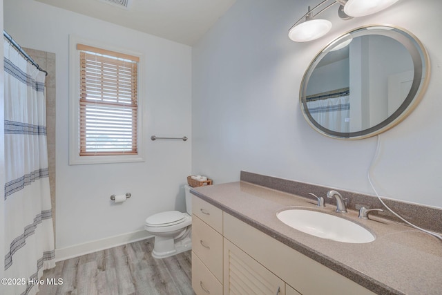 353 Spicer Lake Dr, Holly Ridge, NC 28445 - full bathroom with wood finished floors, vanity, toilet, baseboards, and a shower with curtain