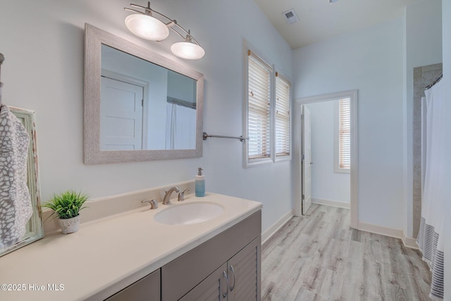 353 Spicer Lake Dr, Holly Ridge, NC 28445 - full bathroom with wood finished floors, vanity, and baseboards