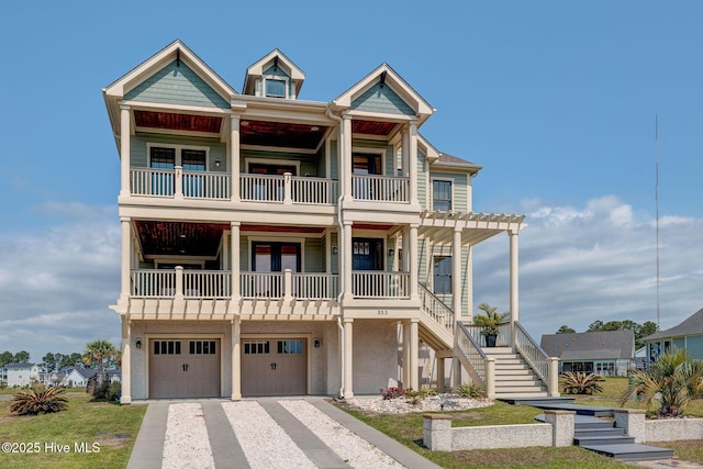353 Spicer Lake Dr, Holly Ridge, NC 28445 - coastal home featuring a balcony, stairway, an attached garage, and driveway