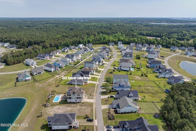 353 Spicer Lake Dr, Holly Ridge, NC 28445 - aerial view of property's location with a heavily wooded area, nearby suburban area, and a large body of water