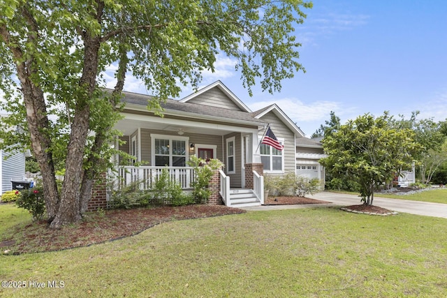 1213 Daisy Ct, Holly Ridge, NC 28445 - view of front facade with covered porch, a front yard, driveway, and a garage