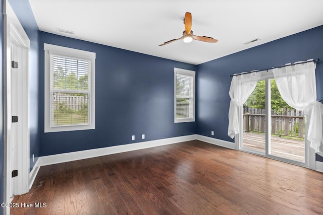 1213 Daisy Ct, Holly Ridge, NC 28445 - empty room with wood finished floors, a ceiling fan, plenty of natural light, and baseboards