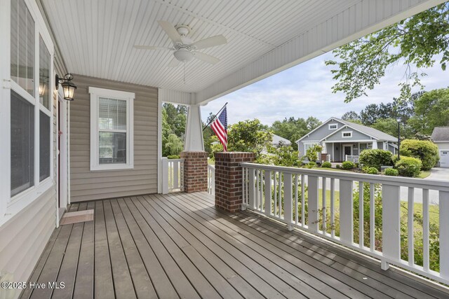 1213 Daisy Ct, Holly Ridge, NC 28445 - wooden deck featuring ceiling fan and a porch