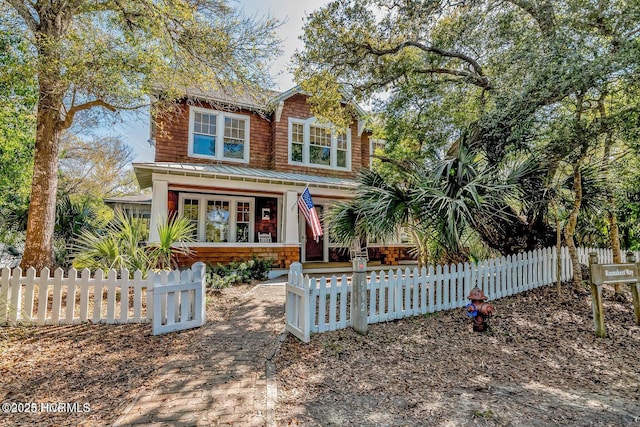 view of front of property with a fenced front yard and metal roof