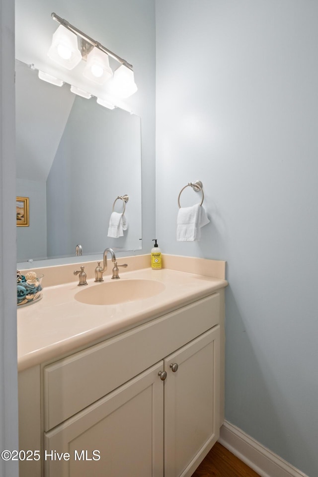 bathroom with vanity and vaulted ceiling