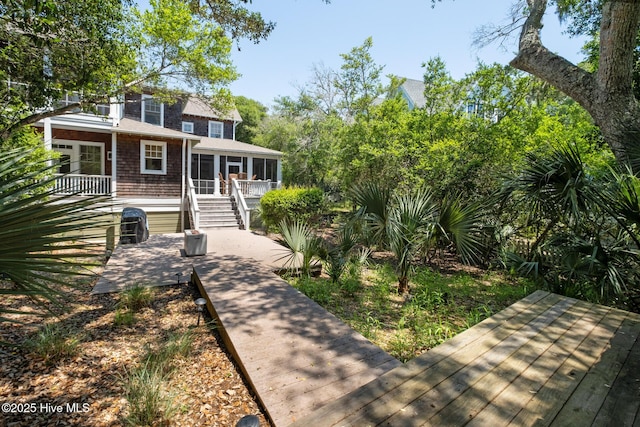 rear view of house with a sunroom and a deck