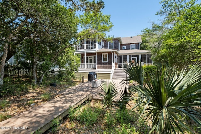 back of house featuring a sunroom