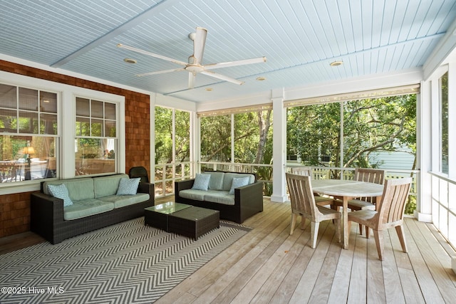 sunroom / solarium with an outdoor hangout area, ceiling fan, and outdoor dining space