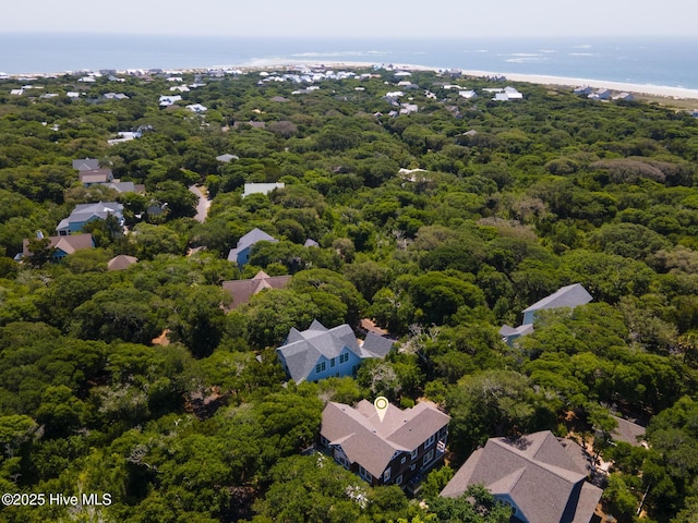 bird's eye view of a heavily wooded area and a nearby body of water