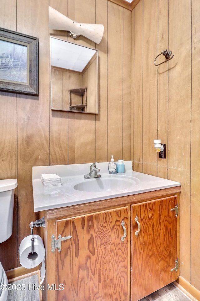 1111 Baxter St, Elizabeth City, NC 27909 - half bath with vanity, toilet, and wooden walls