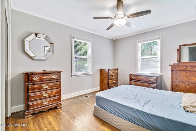 1111 Baxter St, Elizabeth City, NC 27909 - bedroom with crown molding, baseboards, wood finished floors, and ceiling fan