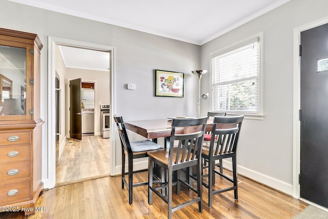 1111 Baxter St, Elizabeth City, NC 27909 - dining space with light wood-style flooring and ornamental molding