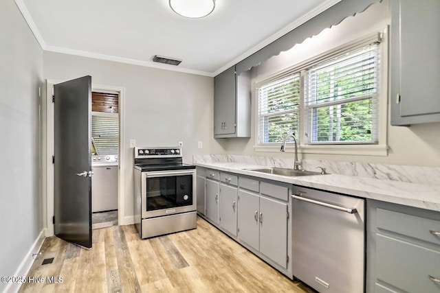 1111 Baxter St, Elizabeth City, NC 27909 - kitchen featuring stainless steel appliances, gray cabinets, crown molding, light wood finished floors, and light stone countertops
