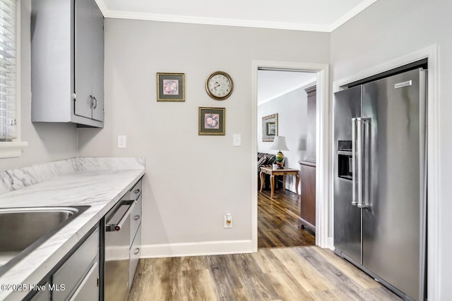 1111 Baxter St, Elizabeth City, NC 27909 - kitchen featuring appliances with stainless steel finishes, wood finished floors, crown molding, gray cabinets, and light countertops