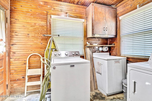 1111 Baxter St, Elizabeth City, NC 27909 - washroom with separate washer and dryer, cabinet space, and wooden walls