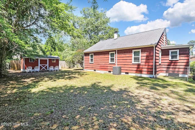 1111 Baxter St, Elizabeth City, NC 27909 - rear view of property with a storage unit, a fenced backyard, a chimney, and roof with shingles
