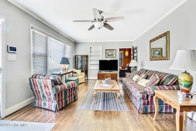 1111 Baxter St, Elizabeth City, NC 27909 - living area with ceiling fan, built in shelves, wood finished floors, baseboards, and ornamental molding