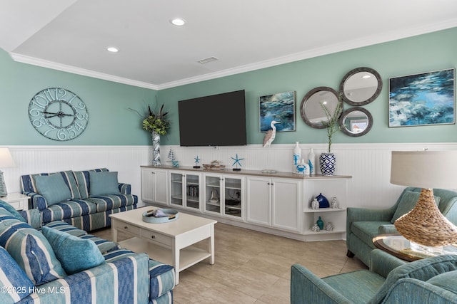 living room featuring wainscoting, ornamental molding, recessed lighting, and light tile patterned flooring