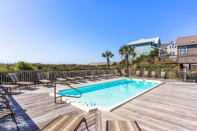community pool with a wooden deck