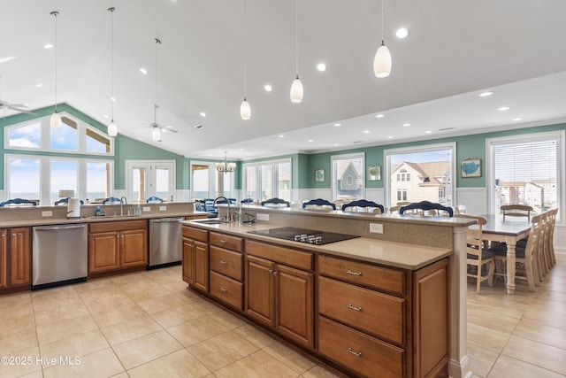 kitchen with stainless steel dishwasher, a ceiling fan, black electric stovetop, wainscoting, and lofted ceiling