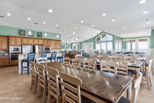 dining space with ceiling fan, light tile patterned floors, high vaulted ceiling, recessed lighting, and a chandelier